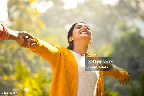 loving couple holding hands at park - wife stock pictures, royalty-free photos & images