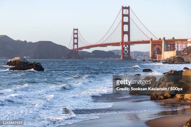 view of suspension bridge over sea,baker beach,united states,usa - baker beach stock pictures, royalty-free photos & images