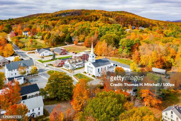 trees and houses against sky during autumn,main st,united states,usa - new hampshire photos et images de collection