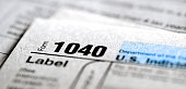 Detail closeup of current tax forms for IRS filing 1040 individual taxes on income