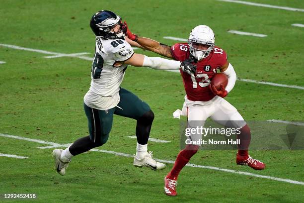 Christian Kirk of the Arizona Cardinals straight arms Dallas Goedert of the Philadelphia Eagles while returning a punt during the fourth quarter at...