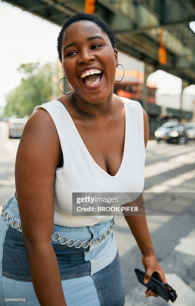Woman laughing on city street