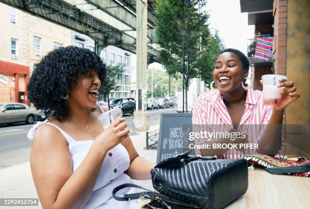 Two women drinking at outdoor restaurant