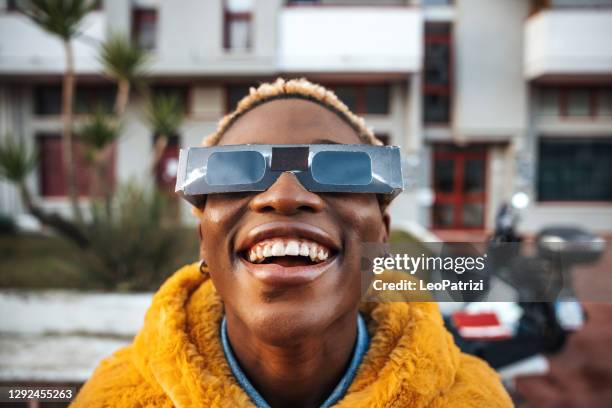 teenage girl looking at solar eclipse - solar eclipse glasses stock pictures, royalty-free photos & images