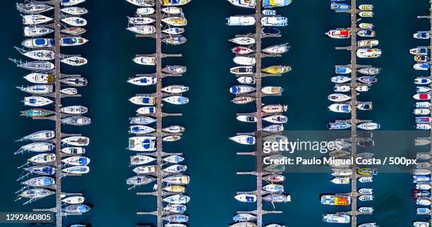 aerial view of boats moored at harbor,passeio dos descobrimentos,portugal - moored stock pictures, royalty-free photos & images