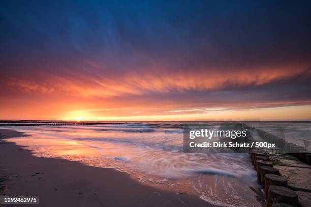 scenic view of beach against sky during sunset - schats stock pictures, royalty-free photos & images