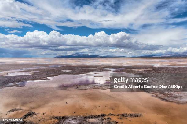 scenic view of landscape against cloudy sky,salinas grandes,salta,argentina - salta argentina stock pictures, royalty-free photos & images