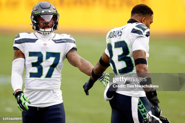 Quandre Diggs of the Seattle Seahawks high fives Jamal Adams against the Washington Football Team FedExField on December 20, 2020 in Landover,...