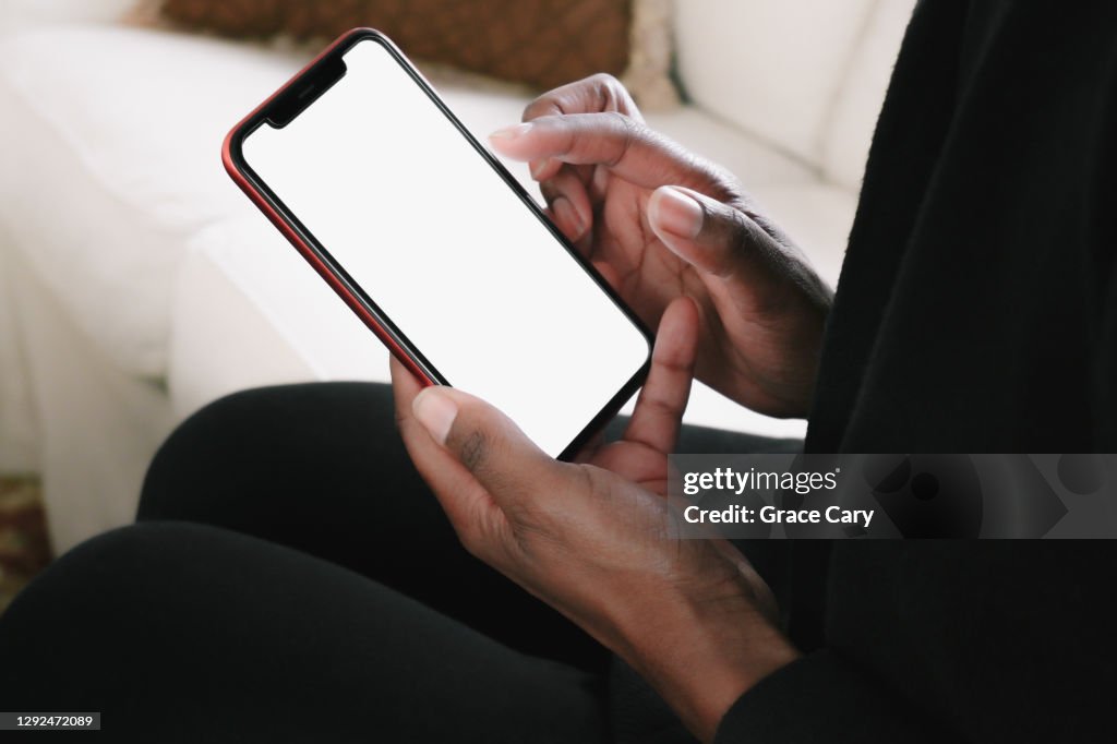 Woman Lounges on Sofa With Smart Phone