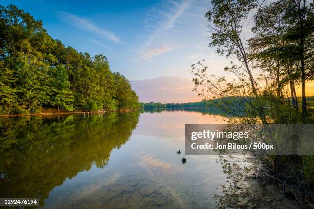 scenic view of lake against sky during sunset - charlotte north carolina photos et images de collection