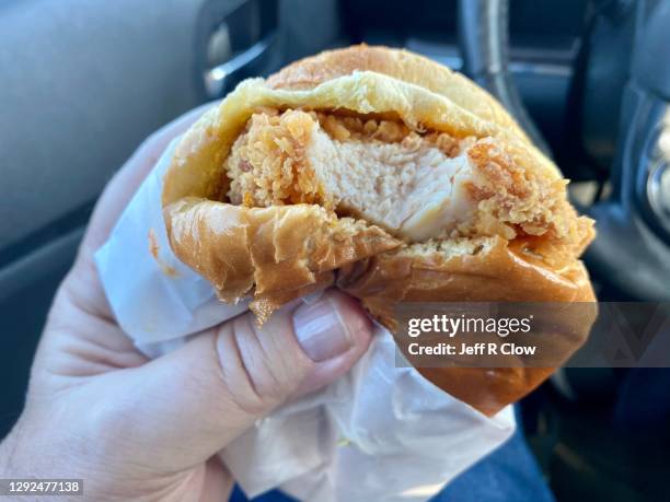 fried chicken sandwich for a fast meal on the road - fried chicken burger stock pictures, royalty-free photos & images