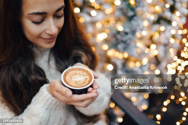 woman with cup of coffee at christmas time. - christmas coffee stock-fotos und bilder