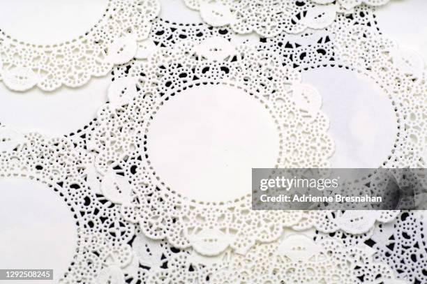 abstract pattern of white lace doilies on a black background - virkad duk bildbanksfoton och bilder