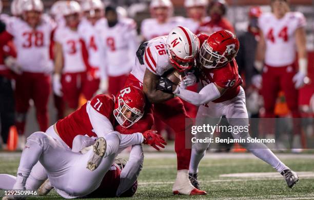 Dedrick Mills of the Nebraska Cornhuskers is tackled during a regular season game against the Rutgers Scarlet Knights at SHI Stadium on December 18,...