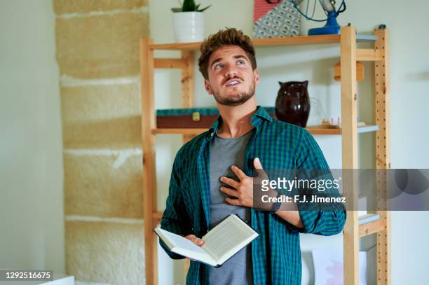 man reading poetry at home - poet stock pictures, royalty-free photos & images