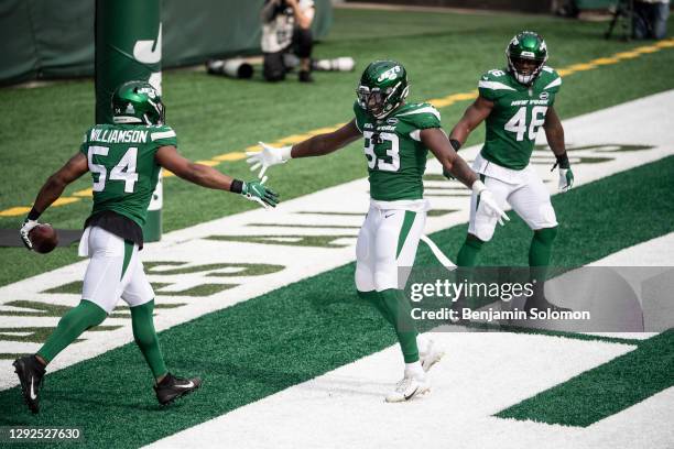 Bryce Hager and Josh Malone of the New York Jets react after scoring a touchdown during a game against the Arizona Cardinals at MetLife Stadium on...
