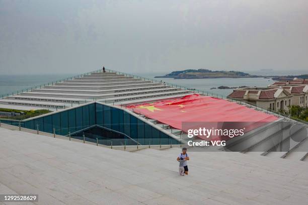 Chinese national flag is laid out on the roof of the Haier World Home Appliance Museum on October 5, 2019 in Qingdao, Shandong Province of China.