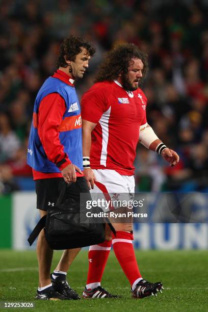 Adam Jones of Wales leaves the field injured during semi final one of the 2011 IRB Rugby World Cup between Wales and France at Eden Park on October...