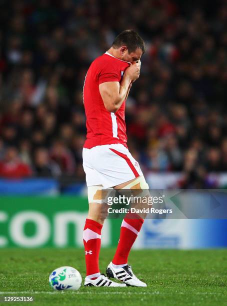 Wales captain Sam Warburton walks off the pitch after receiving a straight red card for a dangerous tackle on Wing Vincent Clerc of France during...