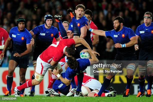 Sam Warburton of Wales upends wing Vincent Clerc of France during semi final one of the 2011 IRB Rugby World Cup between Wales and France at Eden...