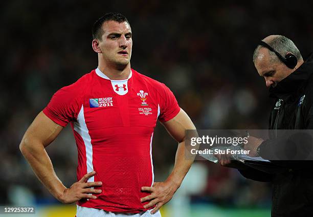 Wales captain Sam Warburton leaves the pitch after receiving a straight red card for a dengerous tackle on Vincent Clerc of France during semi final...