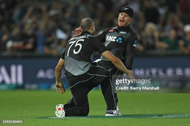 Daryl Mitchell and Glenn Phillips of New Zealand celebrate a wicket during the third game of the International T20 series between New Zealand and...