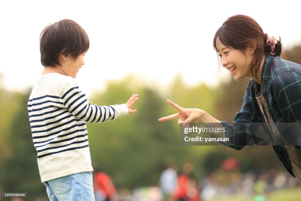 Parent and child playing rock-paper-scissors