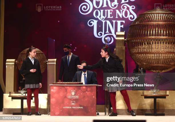 Two of the girls from the San Ildefonso residence sing one of the prizes during the Extraordinary Draw of the 2020 Christmas Lottery at the Teatro...