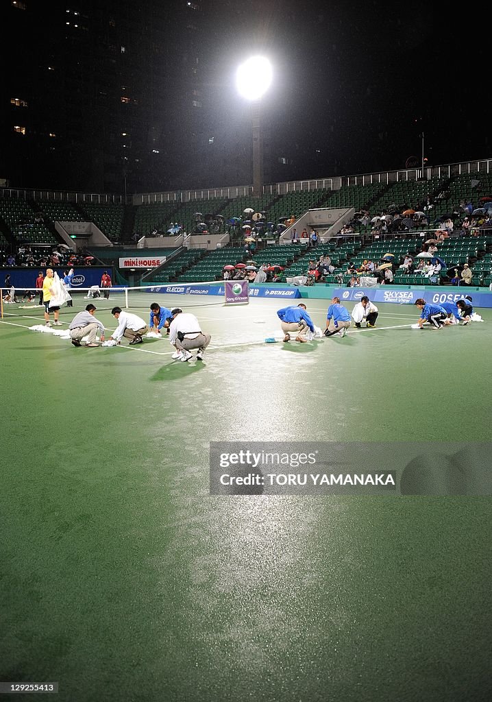 Court staff dry-off center court after r