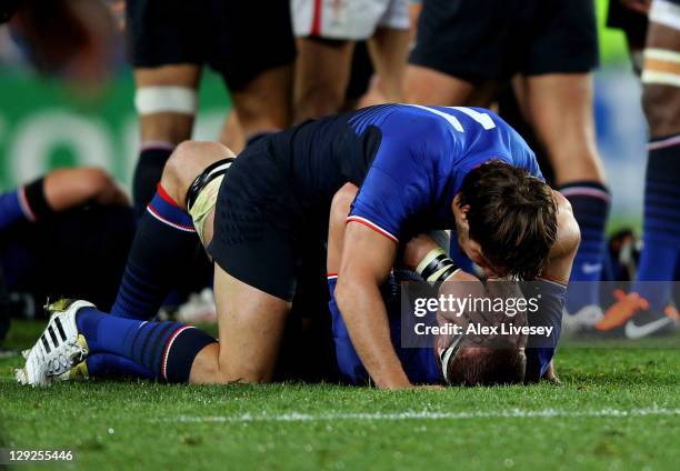 France teammates Alexis Palisson and Imanol Harinordoquy celebrate their team's 9-8 victory as the final whistle blows during semi final one of the...