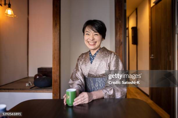 japanese woman talking in old japanese style restaurant - washitsu stock pictures, royalty-free photos & images