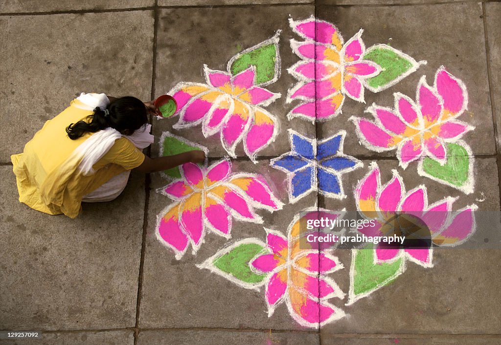 Woman putting rangoli