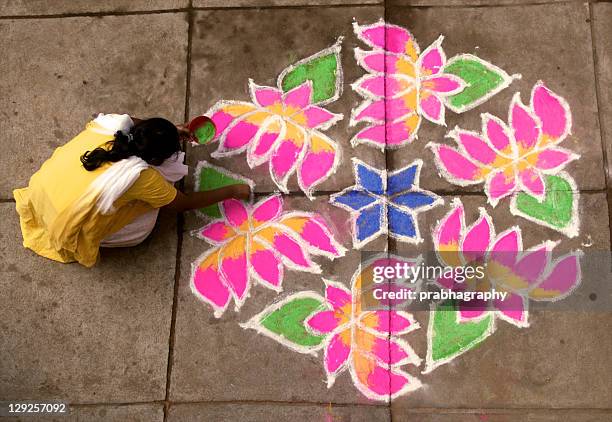 woman putting rangoli - rangoli stock pictures, royalty-free photos & images