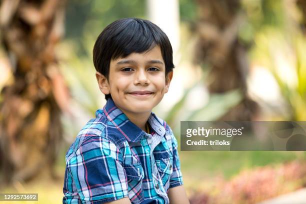 happy boy looking at camera at park - boys stock pictures, royalty-free photos & images