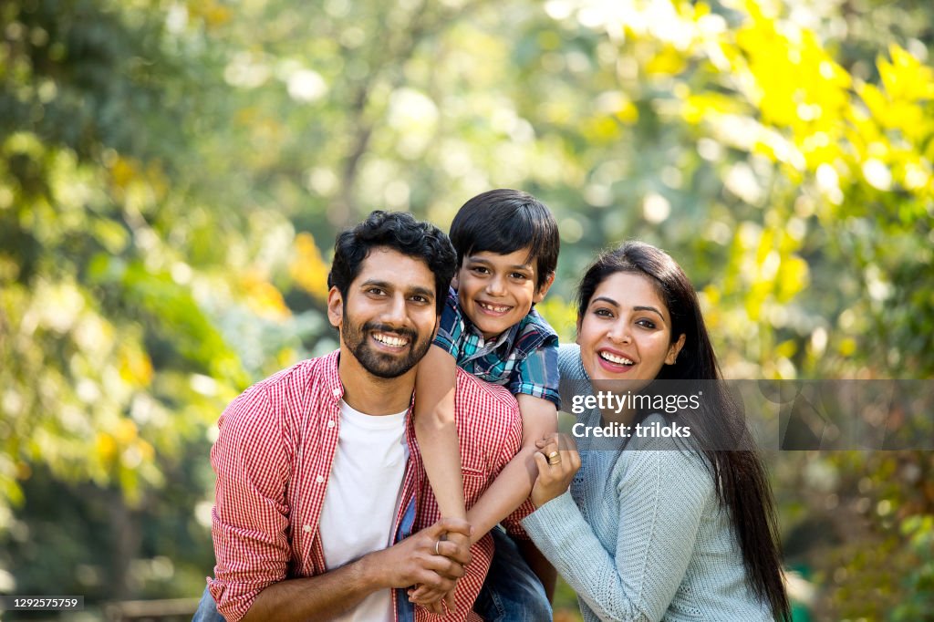 Loving parent and son spending leisure time at park