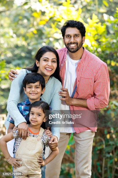 happy indian family having fun at park - indian ethnicity family stock pictures, royalty-free photos & images