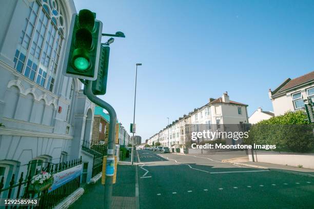 green traffic light on queen's park road in brighton, england - traffic light empty road stock pictures, royalty-free photos & images