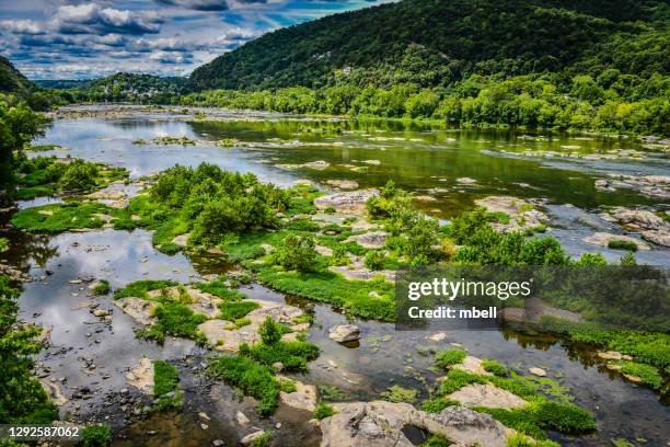 rocks and green foliage on the potomac river at harpers ferry national historical park wv - west virginia v maryland stockfoto's en -beelden