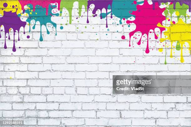 colorful paint splash splatter grunge white brick wall background - colorful mural stock illustrations