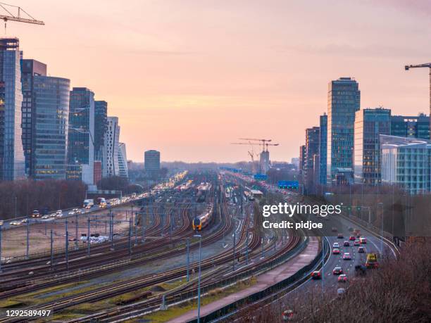 freeway through the zuid-as amsterdam business district - amsterdam zuidas stock pictures, royalty-free photos & images