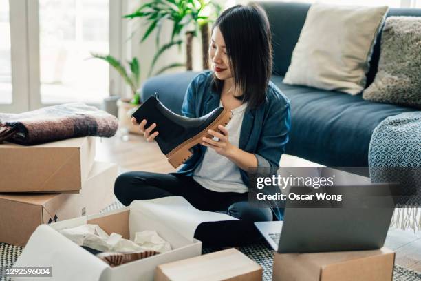 young woman running online business from home - parcel laptop stock pictures, royalty-free photos & images