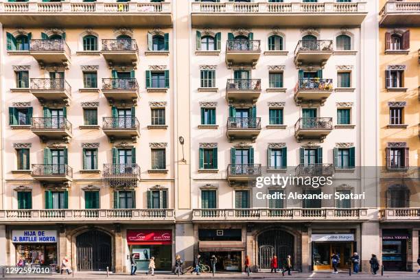 street and house facade in barcelona, spain - façade immeuble photos et images de collection