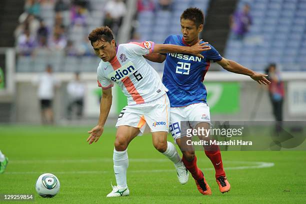 Toshihiro Aoyama of Sanfrecce Hiroshima and Hiroyuki Taniguchi of Yokohama F.Marinos compete for the ball during the J.League match between Yokohama...