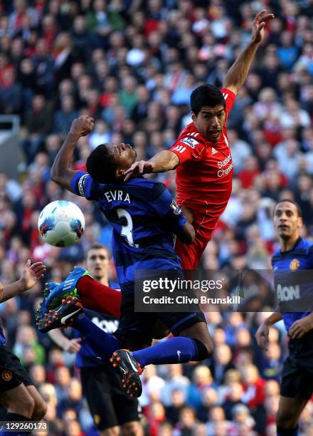 Luis Suarez of Liverpool tangles with Patrice Evra of Manchester United during the Barclays Premier League match between Liverpool and Manchester...