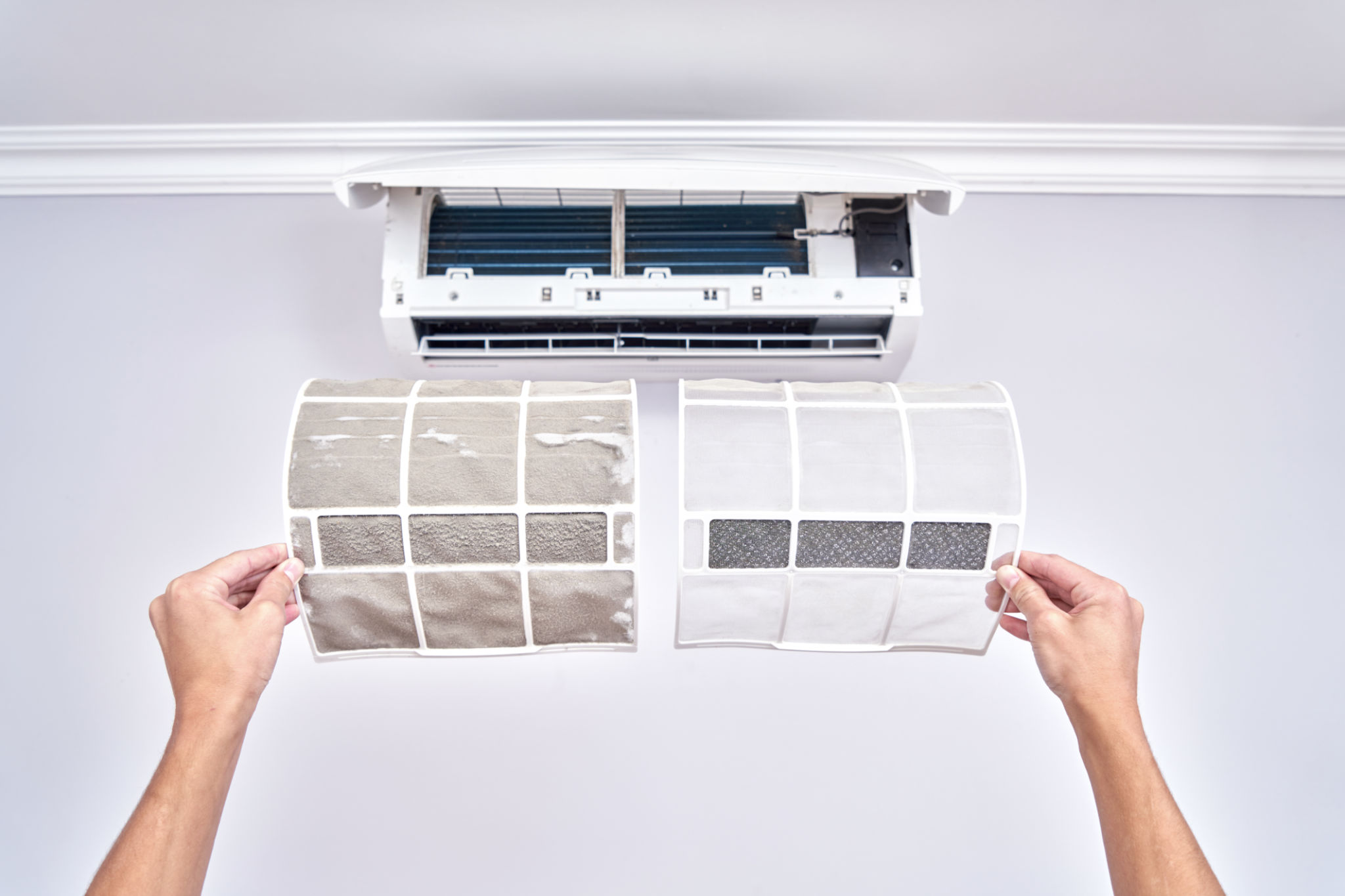 Close up of a clean and dirty filter. Home air conditioner replacement and cleaning concept Close up of a clean and dirty filter. Home air conditioner replacement and cleaning concept