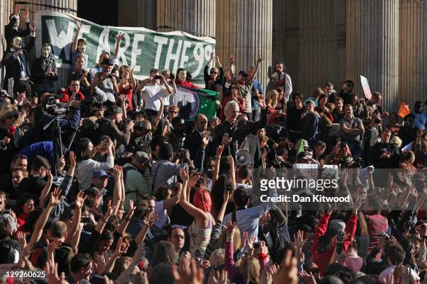 Protesters cheer as Julian Assange, the founder of the WikiLeaks website speaks outside St Paul's Cathedral during the 'Occupy London' protest on...