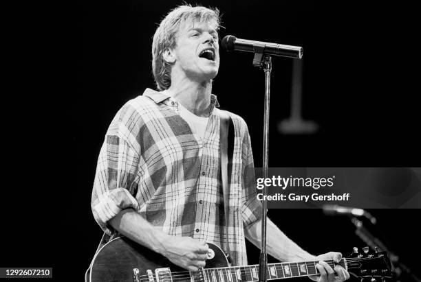 Canadian Rock musician Bryan Adams plays guitar as he performs onstage during the 'Reckless' tour, at Brendan Byrne Arena , East Rutherford, New...