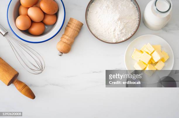 baking homemade bread on white kitchen worktop with ingredients for cooking - butter stock pictures, royalty-free photos & images
