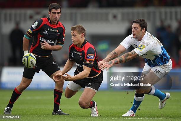 Lewis Robling of Newport Gwent Dragons offloads as Matt Banahan of Bath challenges during the LV Cup match at Rodney Parade on October 15, 2011 in...
