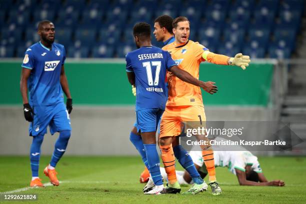 Oliver Baumann of TSG 1899 Hoffenheim celebrates with teammate Ryan Sessegnon after saving a penalty during the DFB Cup second round match between...